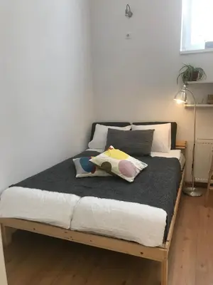 a bedroom with a bed with a black blanket at My Nest, 5 minutes to the Dragon Bridge in Ljubljana