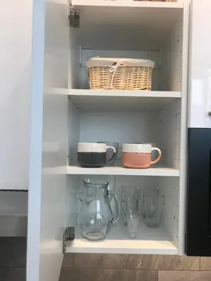 a cupboard with bowls and other kitchen items on it at My Nest, 5 minutes to the Dragon Bridge in Ljubljana