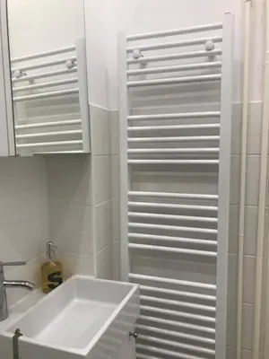 a white bathroom with a sink and a mirror at My Nest, 5 minutes to the Dragon Bridge in Ljubljana
