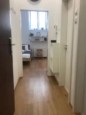 a room with a hallway with a kitchen and a table at My Nest, 5 minutes to the Dragon Bridge in Ljubljana