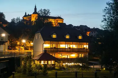 a large house with lights on at night at Hotel Zamorc in Škofja Loka