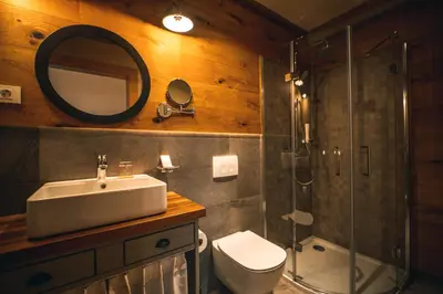 a bathroom with a sink and a shower and a toilet at Hotel Zamorc in Škofja Loka