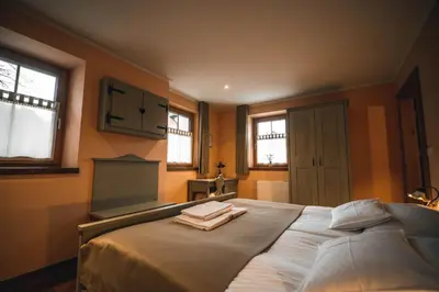 a bedroom with a large bed with towels on it at Hotel Zamorc in Škofja Loka