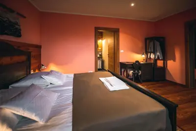 a bedroom with a bed with a towel on it at Hotel Zamorc in Škofja Loka