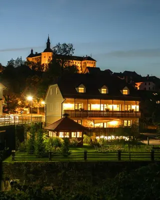 a large house is lit up at night at Hotel Zamorc in Škofja Loka