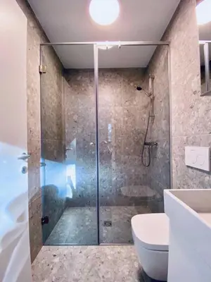 a bathroom with a glass shower and a toilet at Apartments Cokla Zero in Zreče