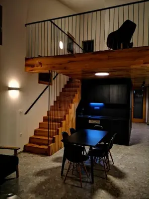 a dining room with a table and a staircase at Apartments Cokla Zero in Zreče