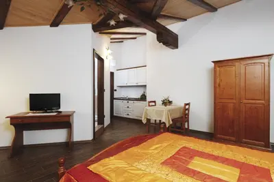 a bedroom with a bed and a table and a television at Pri Marjotu in Kojsko