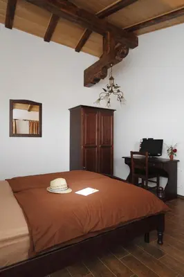 a bedroom with a bed with a hat on it at Pri Marjotu in Kojsko