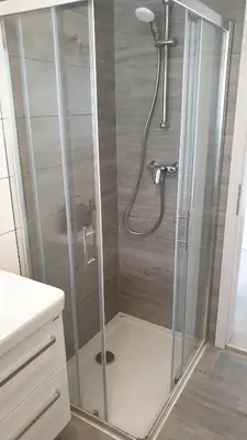 a shower with a glass enclosure in a bathroom at Apartma Vovk in Mojstrana