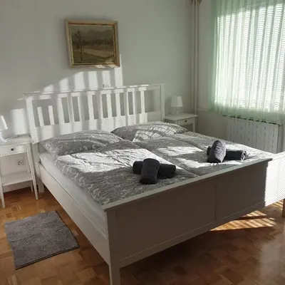 a bedroom with a bed with two pillows on it at Apartma Vovk in Mojstrana