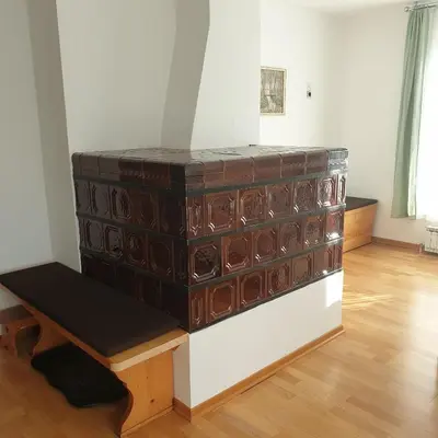 a large wooden chest with a bench in a room at Apartma Vovk in Mojstrana