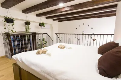 a bedroom with a large white bed with towels on it at Sweet getaway apartment - central & parking in Ljubljana