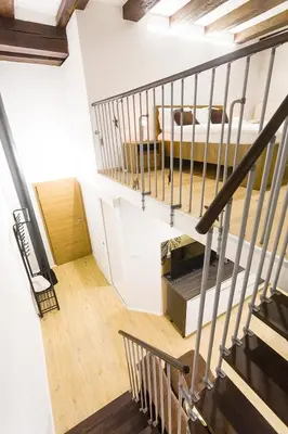 a staircase leading to a room with a bed at Sweet getaway apartment - central & parking in Ljubljana