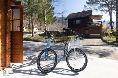 two bikes are parked outside of a house at Vila Rozi, Osilnica - vacation house Pr' Vili Rozi in Osilnica