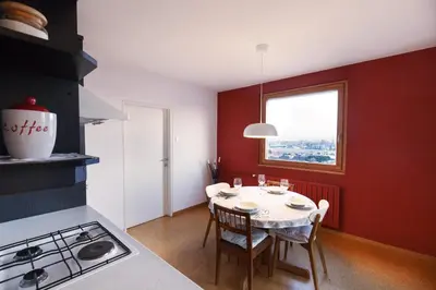a kitchen with a table with chairs and a window at Bright Penthaus Apartement, with a wonderful view in Ljubljana