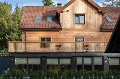a house with a deck on the front of it at House Storz in Pohorje