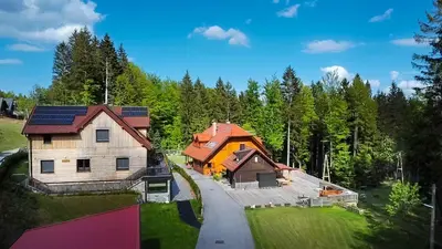 an aerial view of a house with solar panels on it at House Storz in Pohorje