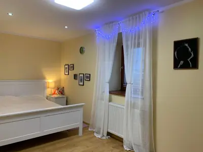 a bedroom with a white bed and a window at Farmhouse Lipoglav in Loče pri Poljčanah