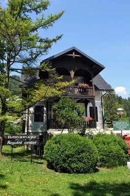 a house with a balcony on top of it at Penzion Zaka in Bled
