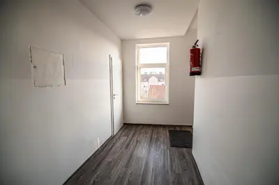 an empty room with a refrigerator and a window at Apartment A1 in Ljubljana