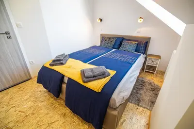 a bedroom with a large bed with blue sheets and towels at Apartment A1 in Ljubljana