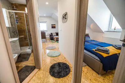 a small bedroom with a bed and a bathroom at Apartment A1 in Ljubljana