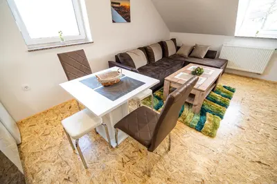 a living room with a table and a couch at Apartment A1 in Ljubljana