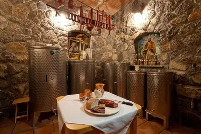 a restaurant with a table with a plate of food at Tourist Farm Škrbina in Otočec
