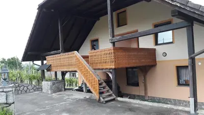 a wooden staircase on the side of a building at Tourist Farm Škrbina in Otočec