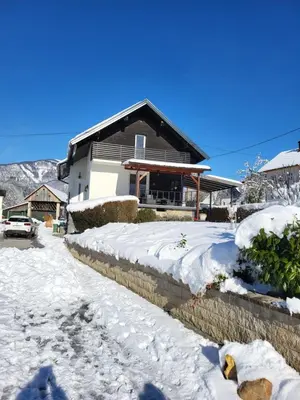 a house with snow in front of it at Holiday Home NA VASI in Gorenja Vas