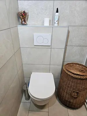 a bathroom with a toilet and a basket at Holiday Home NA VASI in Gorenja Vas