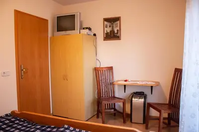 a room with a bed and a table and a cabinet at Turistična kmetija Dreisiebner in Špičnik