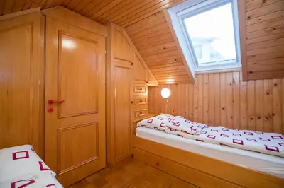 a small room with a bed and a window at Počitniška hiša Žvan in Bohinj