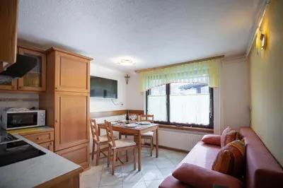 a kitchen with a table and a dining room at Počitniška hiša Žvan in Bohinj