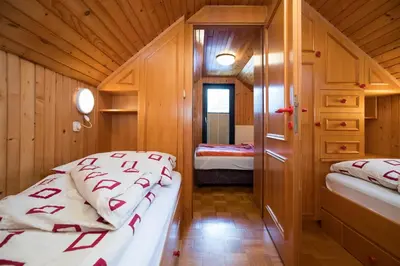 a small room with two beds in a cabin at Počitniška hiša Žvan in Bohinj