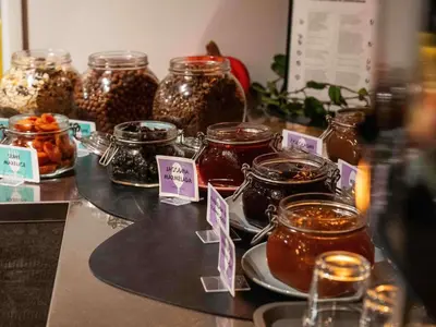 a table with jars of honey and jars of food at ibis Styles Ljubljana The Fuzzy Log in Ljubljana
