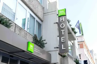 a hotel sign on the side of a building at ibis Styles Ljubljana The Fuzzy Log in Ljubljana