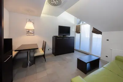a small living room with a table and a television at Apartments Trio in Kranjska Gora