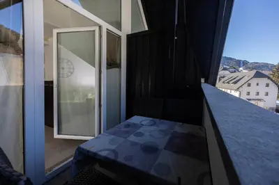 a balcony with a blue counter top and a window at Apartments Trio in Kranjska Gora