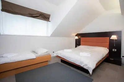 a bedroom with two beds and a window at Apartments Trio in Kranjska Gora