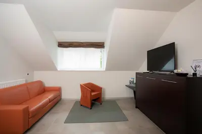 a living room with a couch and a flat screen tv at Apartments Trio in Kranjska Gora