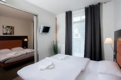 a hotel room with two beds and a window at Apartments Trio in Kranjska Gora
