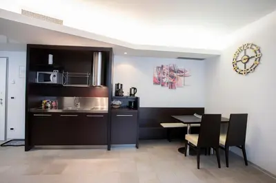 a kitchen with a table and a microwave at Apartments Trio in Kranjska Gora