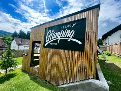 a building with a sign on the side of it at Glamping Langus in Topolšica