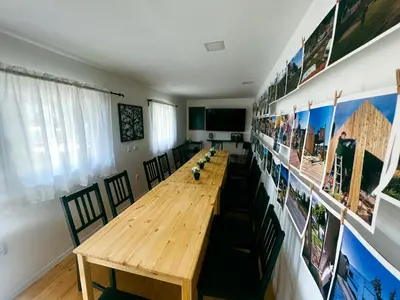 a conference room with a long wooden table and chairs at Glamping Langus in Topolšica