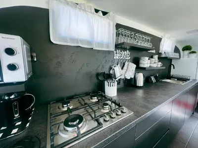 a kitchen with a stove top oven in a kitchen at Glamping Langus in Topolšica
