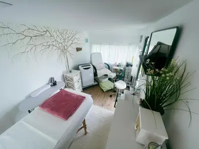 a white room with a bed and a mirror at Glamping Langus in Topolšica