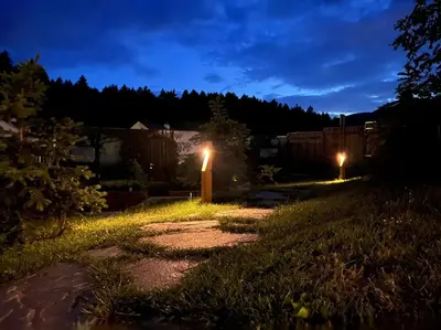 a garden at night with lights in the grass at Glamping Langus in Topolšica