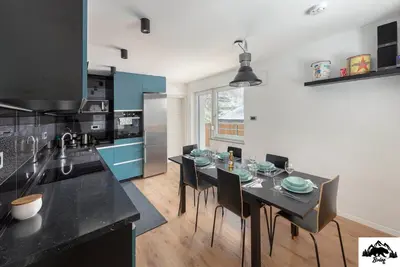 a kitchen with a table and chairs in a room at Brlog in Zgornje Gorje